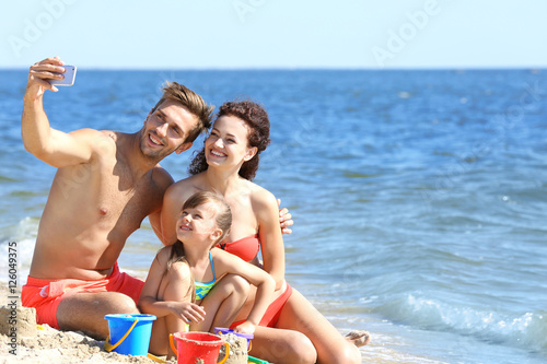 Cheerful family taking self...