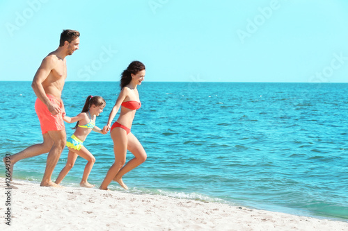 Cheerful parents and little...
