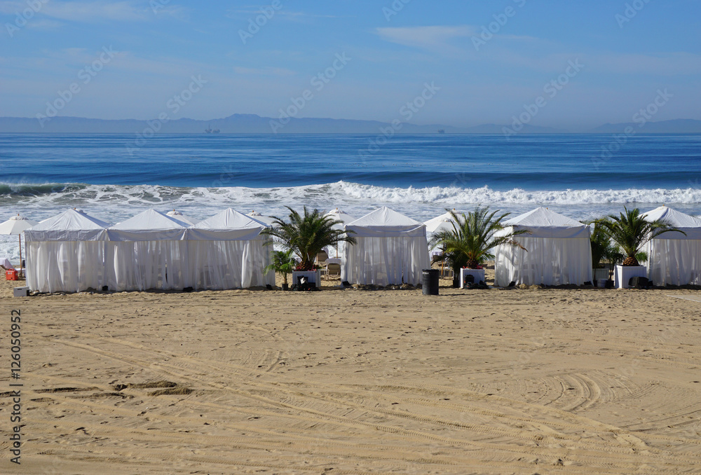 cabanas on beach with waves in background Stock Photo Adobe Stock
