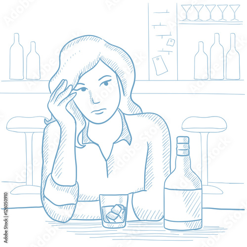 Woman drinking alcoholic drink at the bar.