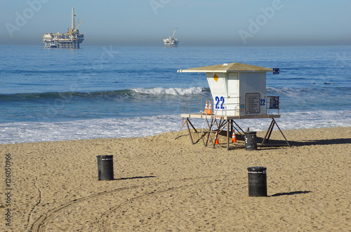 lifeguard tower on beach with oil platforms in background © jdoms