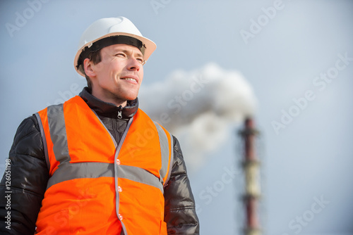 Worker with factory on the background