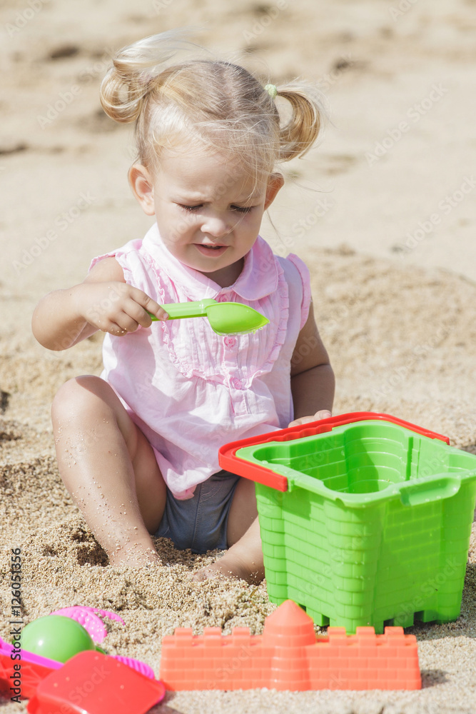 little baby girl playing sand toys at the beach little baby girl playing sand toys at the beach