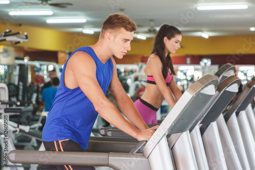 sporty man and woman on treadmill