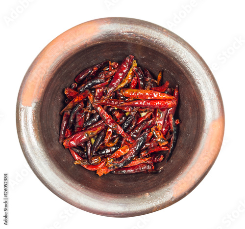 Roested dried red chili pepper in mortar on white background photo