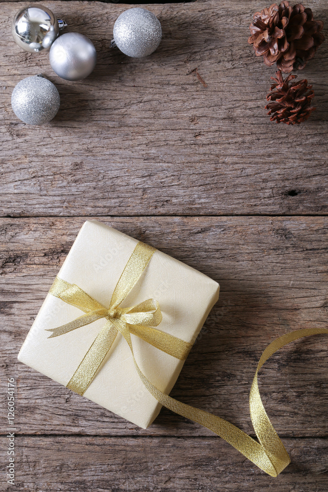 Present on wooden surface with christmas decoration Present on wooden surface with christmas decoration