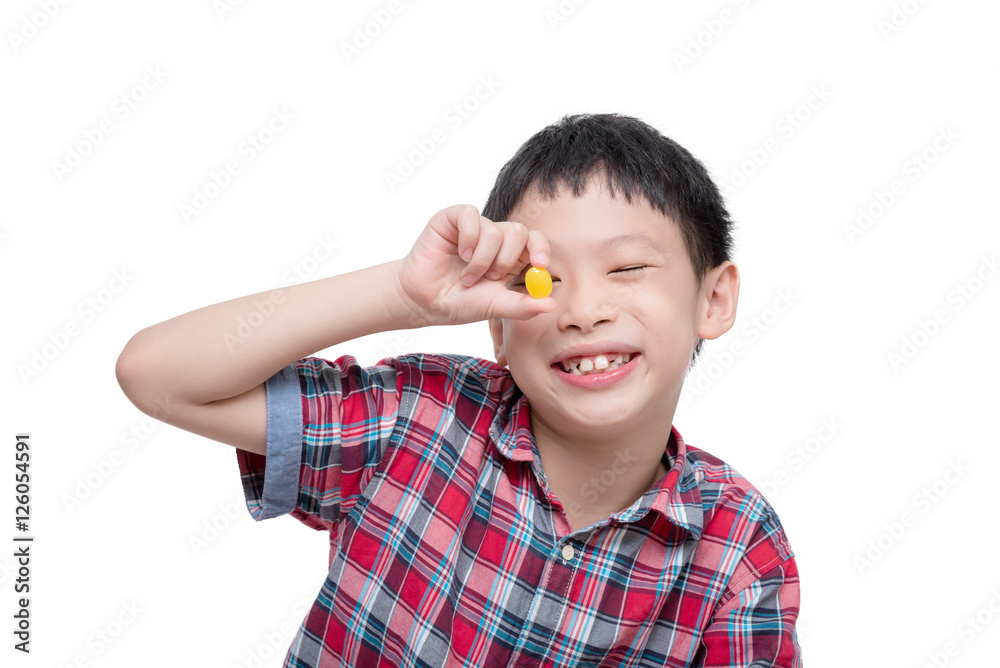Young Asian boy with candy isolated over white Young Asian boy with candy isolated over white