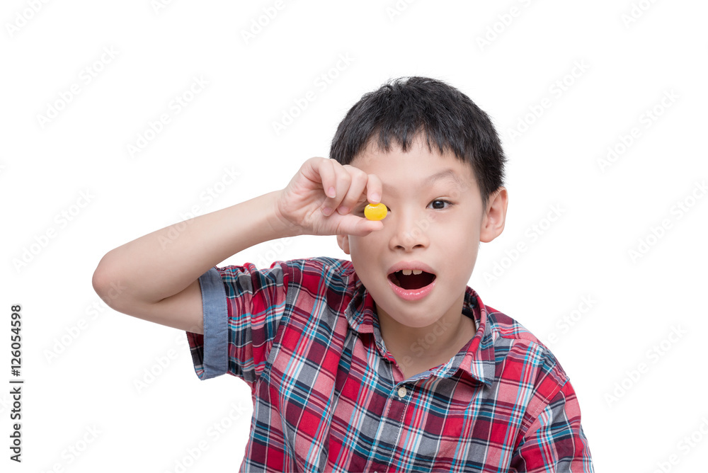 Young Asian boy with candy isolated over white Young Asian boy with candy isolated over white