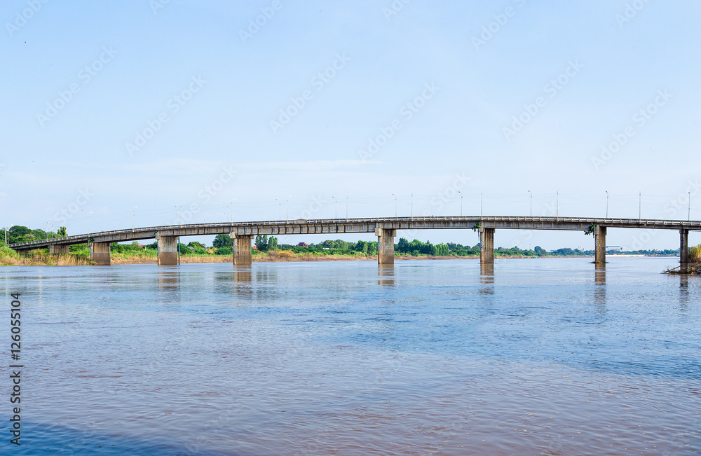 A concrete bridge passing over the river at  Thailand