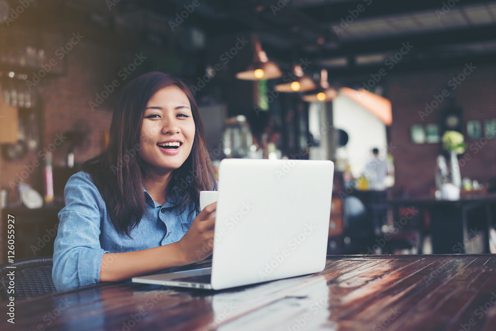 Beautiful young hipster woman sitting in a coffee shop, holding Beautiful young hipster woman sitting in a coffee shop, holding
