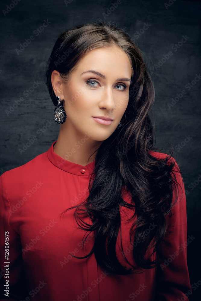 Portrait of a brunette woman with waving hair in a red shirt. Portrait of a brunette woman with waving hair in a red shirt.