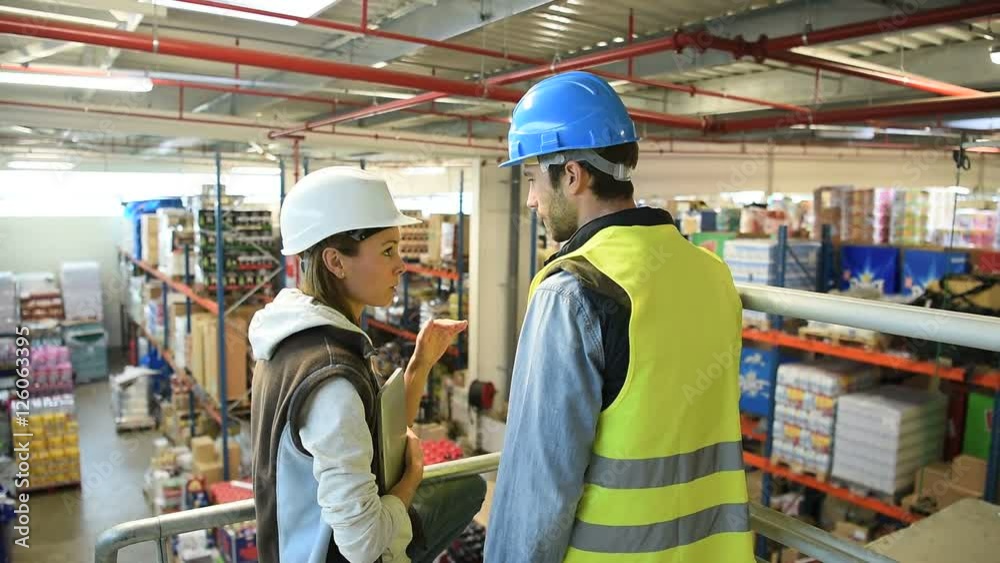 Warehouse manager giving instructions to operator Warehouse manager giving instructions to operator
