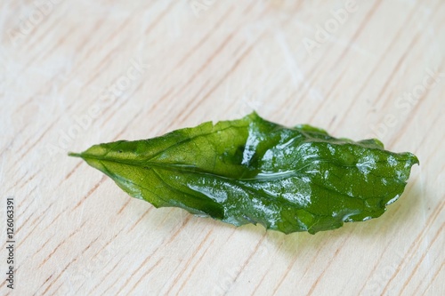 Holy basil fried on a wooden cutting board
