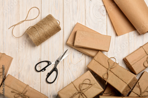 Wrapping Christmas gifts in Kraft paper and rope.