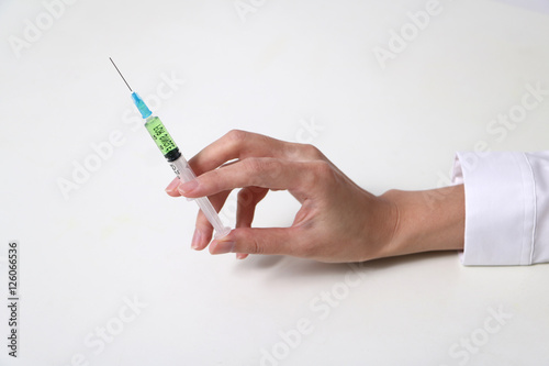 injector held by woman hand photo