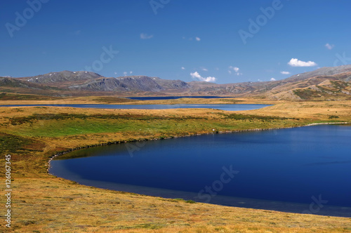 Colorful vibrant highland landscape steppe shore of a deep blue