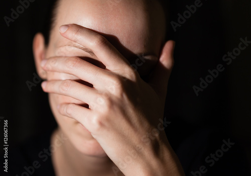 Fotografie, Tablou Portrait of sad woman with hand over face.