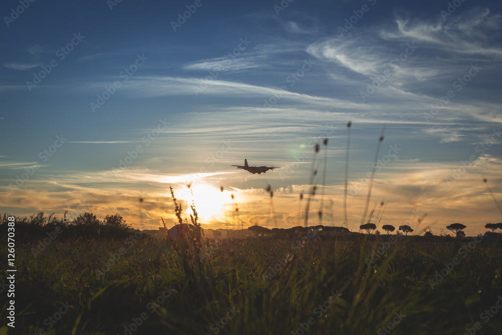Obraz premium Military C-130 transporter Airplane is Approaching at the Airport.