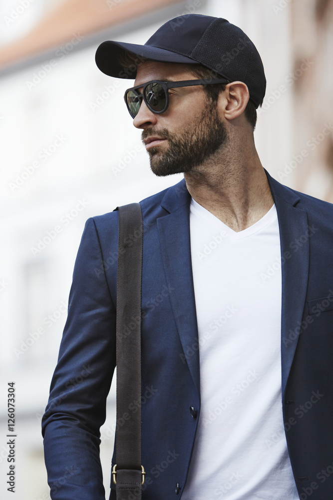 Stubble and shades man looking away, in city Stubble and shades man looking away, in city