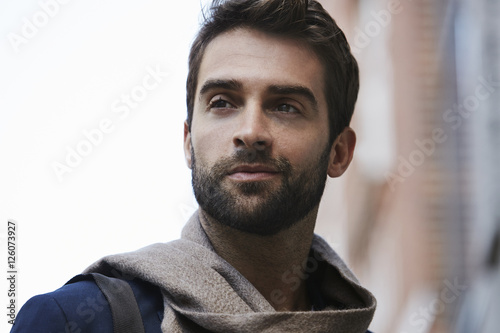 Scarf and stubble man looking away