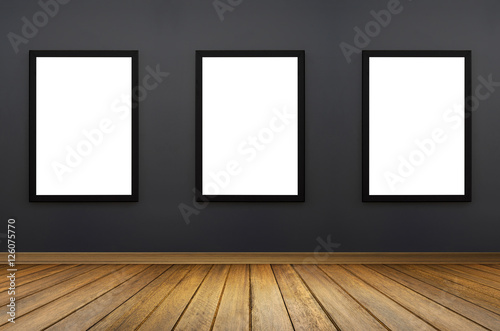 three Black frame hanging on a grey wall.white isolate.perspective wooden floor.for advertiser.graphic design