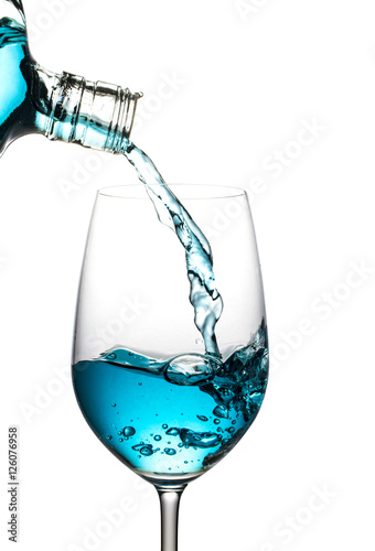 Blue wine was poured, spread isolated white background.