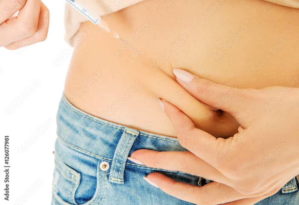 Fototapeta premium Woman diabetic does herself insulin injection