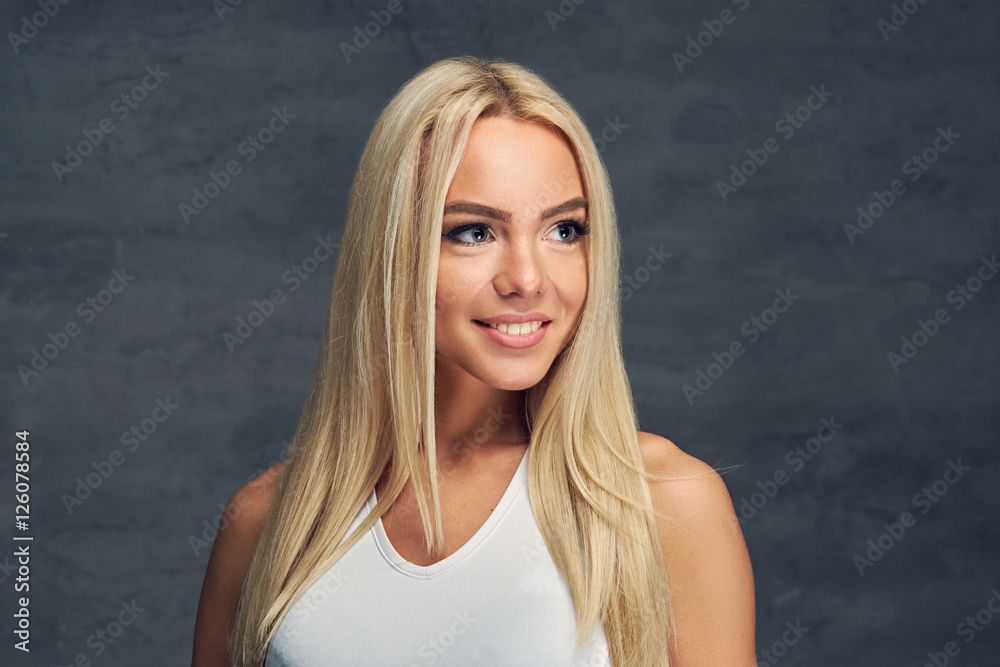 A girl in white t shirt on grey background. A girl in white t shirt on grey background.