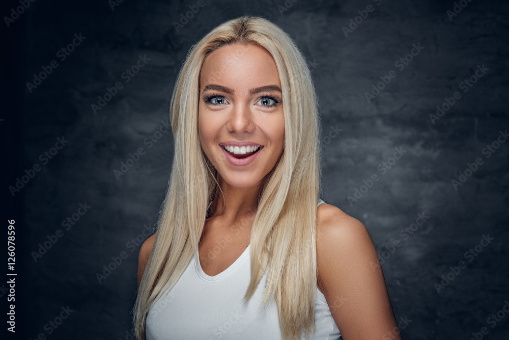 A girl in white t shirt on grey background. A girl in white t shirt on grey background.