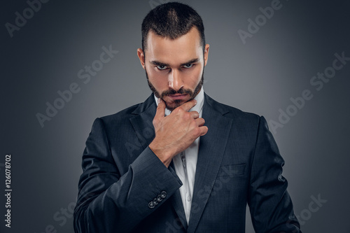 A man in a suit isolated on grey background.