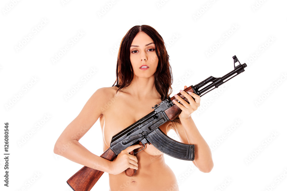 Sexy nude brunette girl model with weapon.