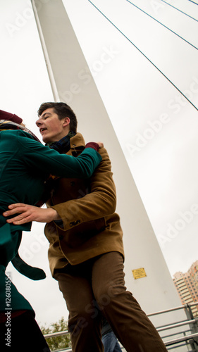 young boy and girl on a date in the winter on a bridge