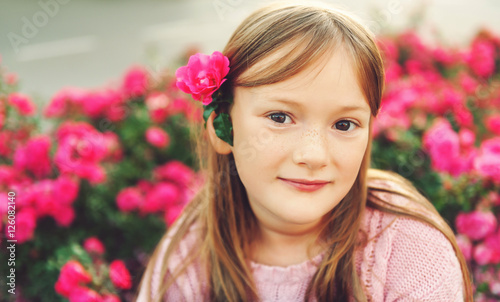 Close up portrait of a cute little girl resting outdoors on a nice sunny evening