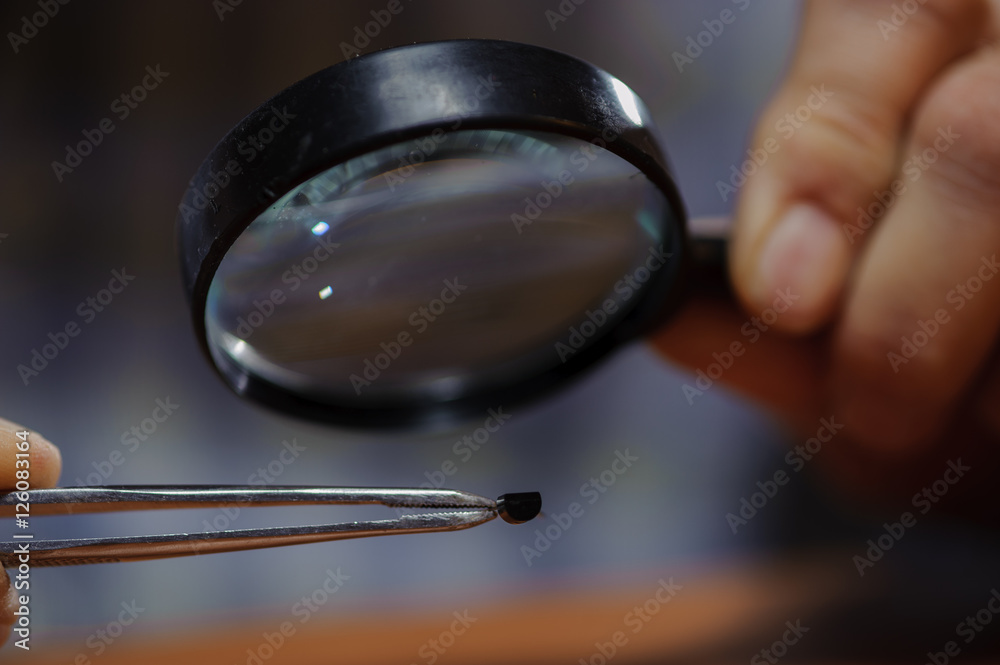 Obraz premium Electrical engineer checking diode with magnifier