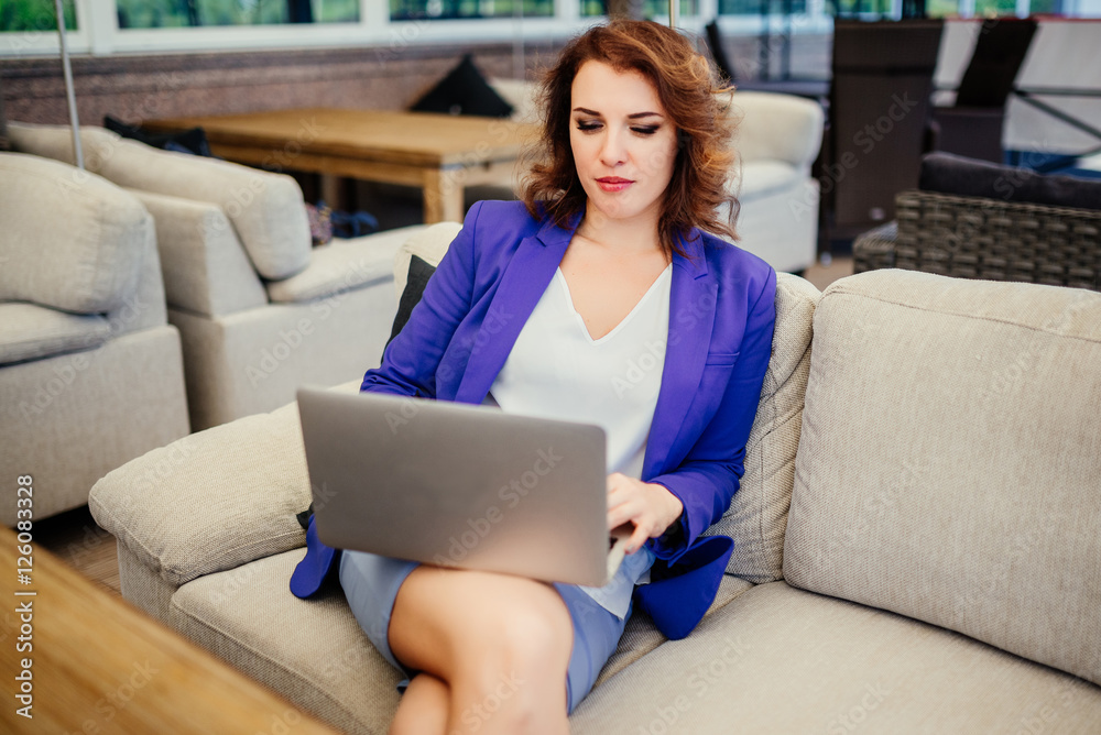 Cute woman successful businesslady using laptop computer while sitting in lounge cafe. Businesslady thinking about new ideas during work on laptop computer. Business concept. Cute woman successful businesslady using laptop computer while sitting in lounge cafe. Businesslady thinking about new ideas during work on laptop computer. Business concept.