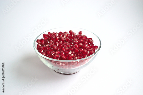 Pomegranate seeds in a clear bowl