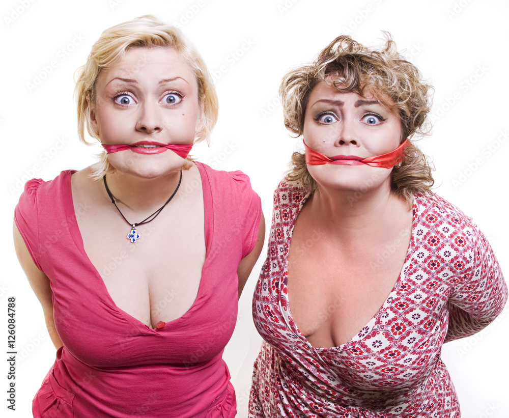 Foto Stock two adult fat women hostages tied up with the mouth.