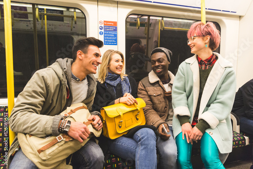 Group of young friends travelling together by tube