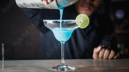 Barman pouring Margarita cocktails.