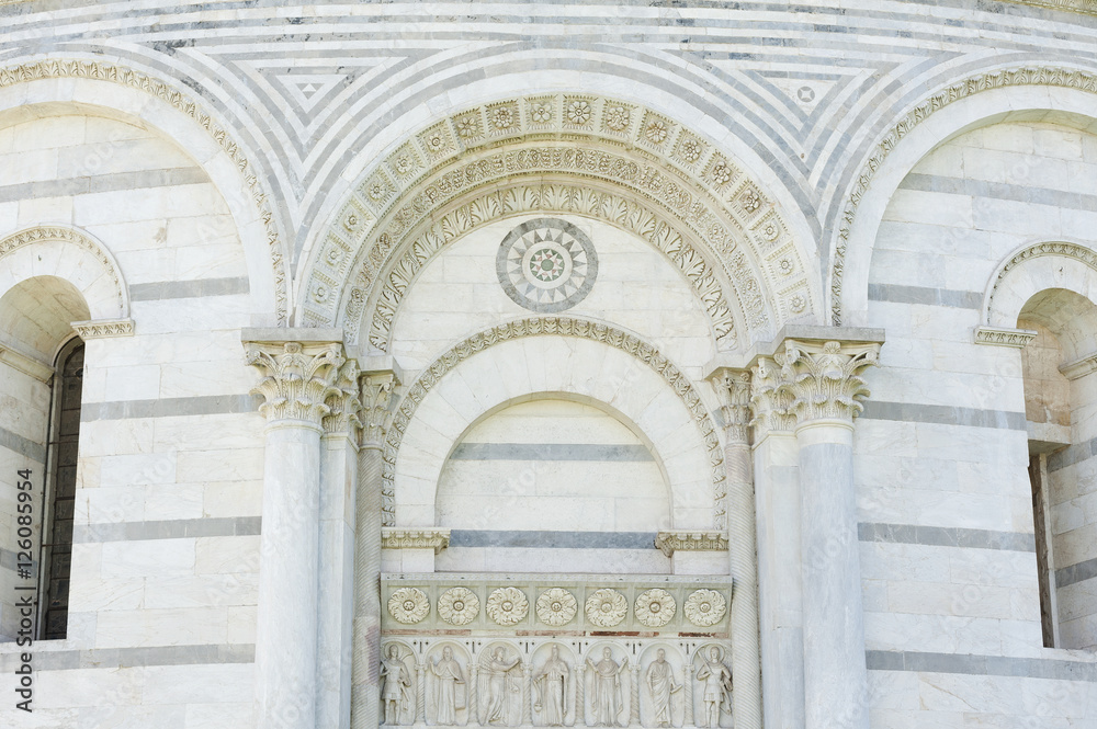 Classical wall with graceful columns and arches in Pisa, Italy