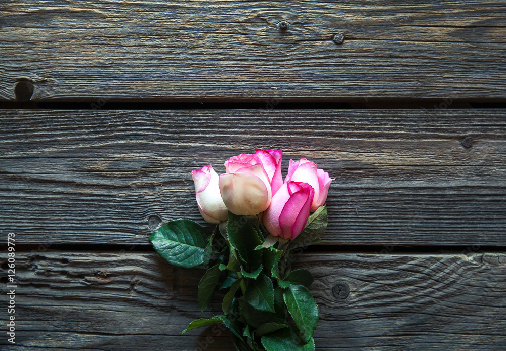 Pink roses bouquet over wooden table. Top view with copy space. flowers