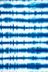 striped tie dye pattern on cotton fabric abstract background.
