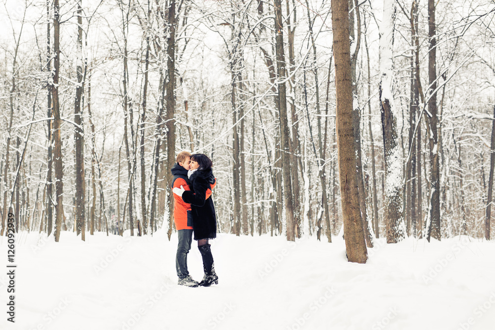 Young couple kissing on winter day