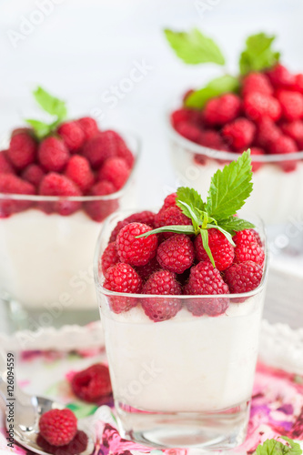 Delicious sweet  mousse decorated with fresh raspberries