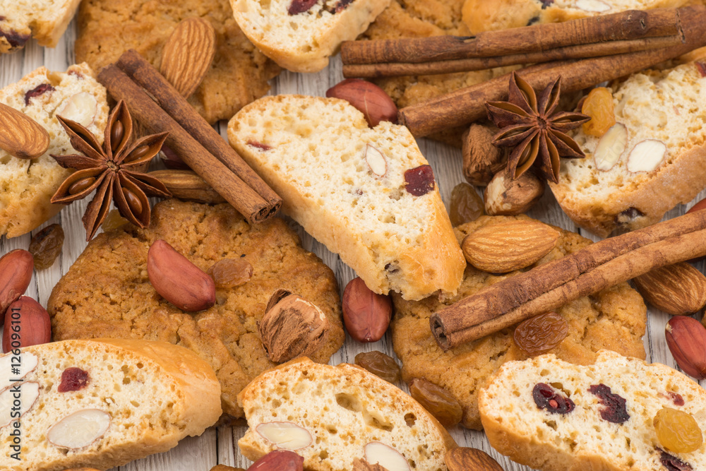 Cookies with almonds and raisins on the old wooden table.