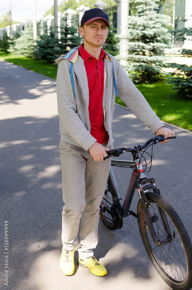 Naklejka premium Young man with bicycle