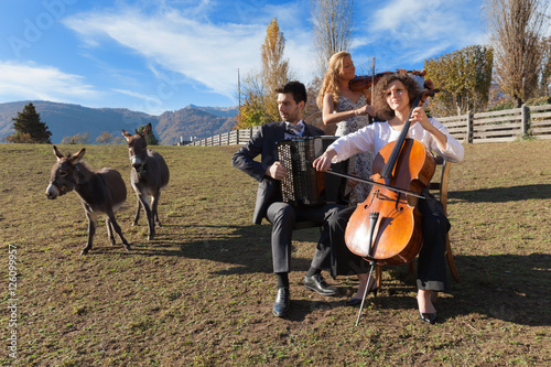 three young musicians, outdoors