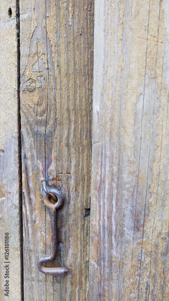 The lock a hook on an old door.