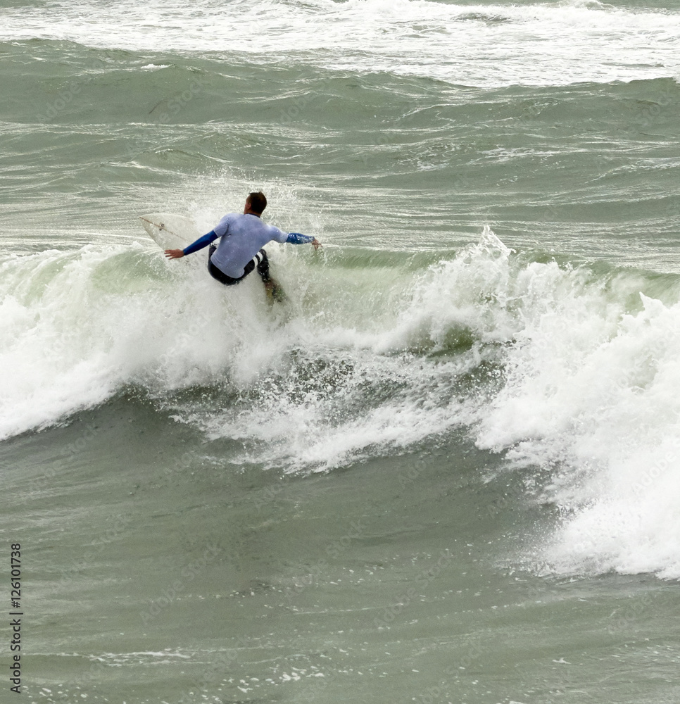 a surfer surf a wave in italy