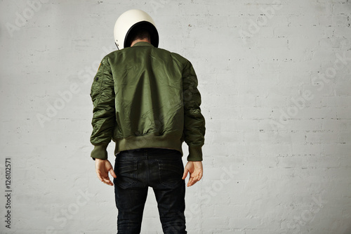 Fotomurale Athletic young model in skinny jeans, green bomber jacket and white motorcycle h